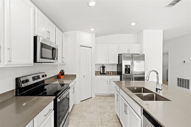 1291 Lassen St, Haines City, FL 33844 - kitchen featuring appliances with stainless steel finishes, white cabinetry, recessed lighting, and light tile patterned floors