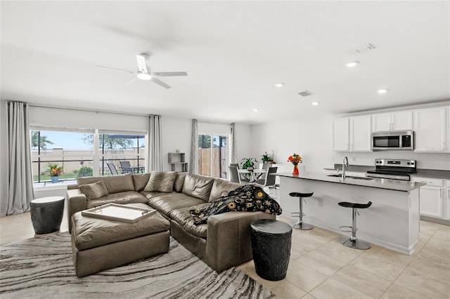 1291 Lassen St, Haines City, FL 33844 - living area with light tile patterned floors, a ceiling fan, and recessed lighting