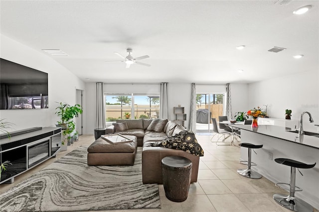 1291 Lassen St, Haines City, FL 33844 - living room with a ceiling fan, light tile patterned flooring, and recessed lighting