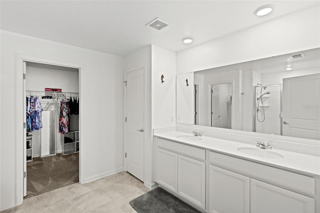 1291 Lassen St, Haines City, FL 33844 - bathroom with double vanity, a stall shower, and a spacious closet