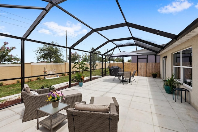 1291 Lassen St, Haines City, FL 33844 - fenced backyard featuring a patio area, glass enclosure, outdoor dining space, and outdoor lounge area