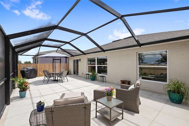 1291 Lassen St, Haines City, FL 33844 - view of patio / terrace featuring a grill, a lanai, and outdoor dining space