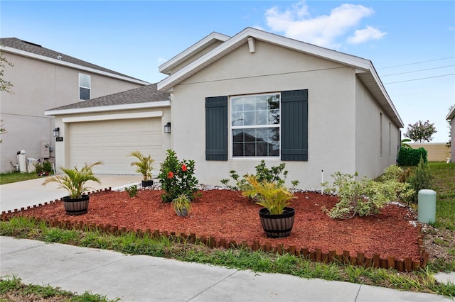 1291 Lassen St, Haines City, FL 33844 - view of front of house with an attached garage, stucco siding, driveway, and roof with shingles