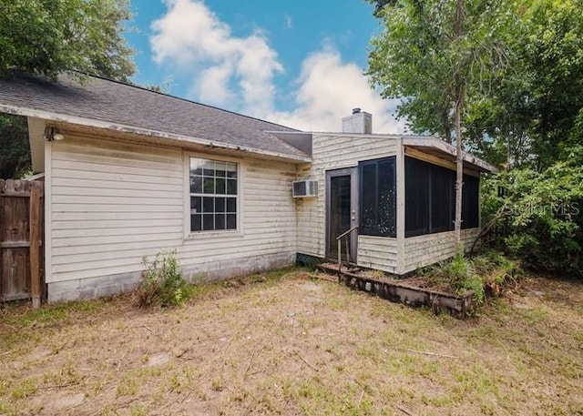 6140 SE 46th Avenue Rd, Ocala, FL 34480 - rear view of house with a sunroom, a chimney, and a wall mounted air conditioner