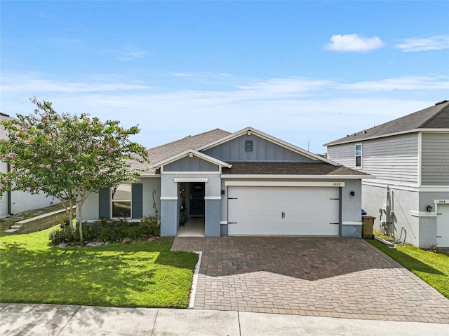 1668 Wilson Prairie Cir, Groveland, FL 34736 - single story home with an attached garage, board and batten siding, roof with shingles, decorative driveway, and a front lawn