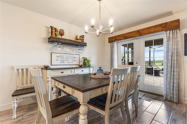 1668 Wilson Prairie Cir, Groveland, FL 34736 - dining space with french doors, a chandelier, wood finished floors, and a bar
