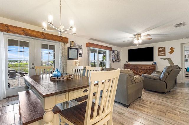 1668 Wilson Prairie Cir, Groveland, FL 34736 - dining room with a chandelier, light wood-style floors, and ceiling fan