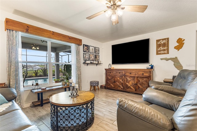 1668 Wilson Prairie Cir, Groveland, FL 34736 - living room featuring a ceiling fan and light wood-style floors