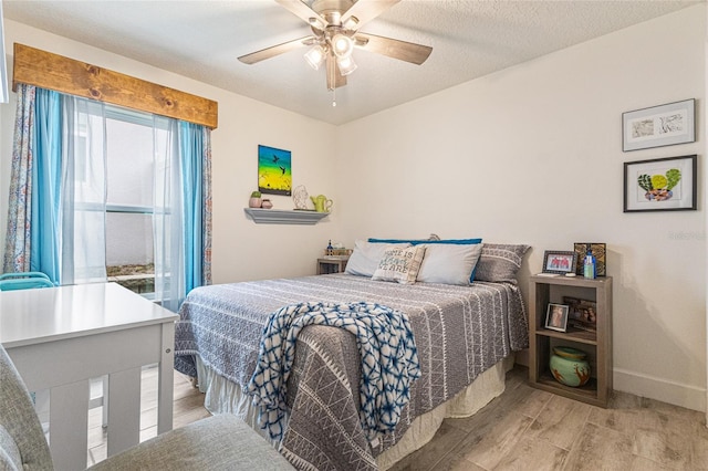 1668 Wilson Prairie Cir, Groveland, FL 34736 - bedroom with light wood finished floors and a ceiling fan