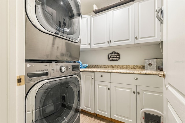 1668 Wilson Prairie Cir, Groveland, FL 34736 - laundry area with cabinet space, stacked washing machine and dryer, and light wood finished floors