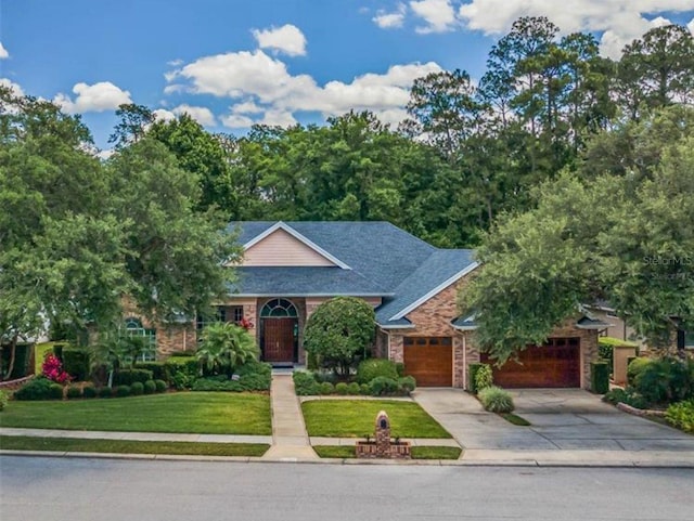 1915 Cotswold Dr, Orlando, FL 32825 - view of front facade with a garage, driveway, and a front yard