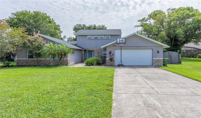 5361 Jade Cir, Belle Isle, FL 32812 - view of front of house with stone siding, an attached garage, and concrete driveway