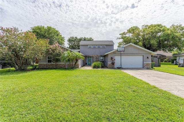 5361 Jade Cir, Belle Isle, FL 32812 - view of front facade featuring stone siding, a garage, driveway, and a front yard