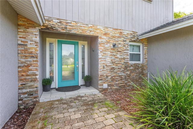 5361 Jade Cir, Belle Isle, FL 32812 - doorway to property featuring stone siding and stucco siding