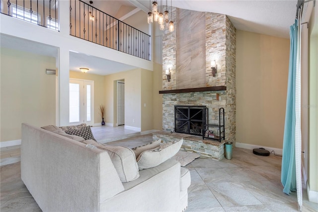 5361 Jade Cir, Belle Isle, FL 32812 - living room with a high ceiling, a stone fireplace, and a chandelier