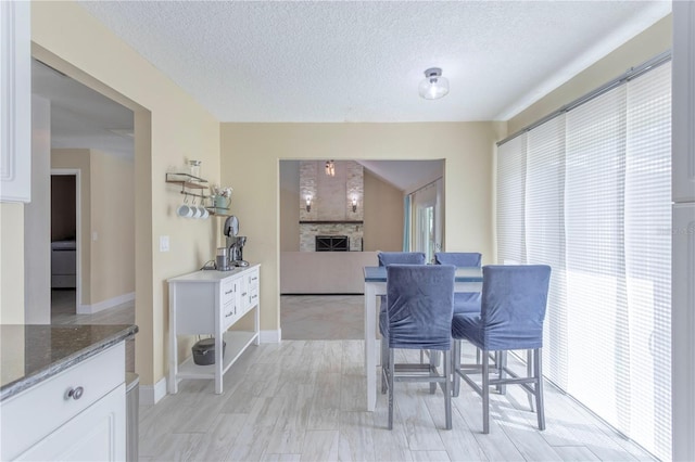 5361 Jade Cir, Belle Isle, FL 32812 - dining area featuring a fireplace and a textured ceiling