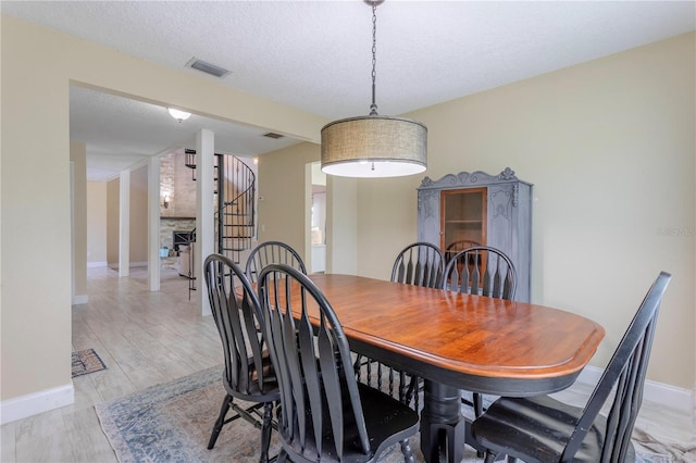 5361 Jade Cir, Belle Isle, FL 32812 - dining space with stairs, a textured ceiling, and light wood-type flooring