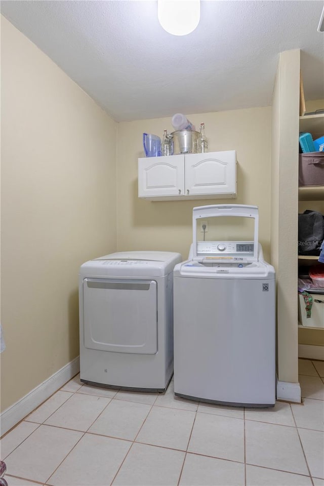 5361 Jade Cir, Belle Isle, FL 32812 - laundry room featuring washer and dryer, cabinet space, and light tile patterned floors
