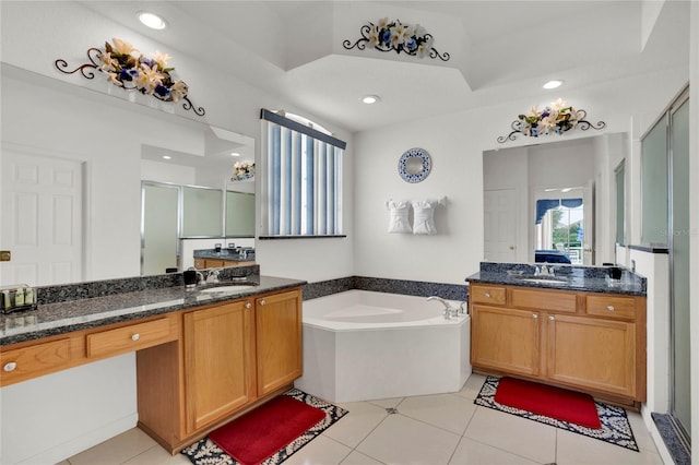 429 Belfry Dr, Davenport, FL 33897 - bathroom with a shower stall, a bath, two vanities, tile patterned floors, and recessed lighting