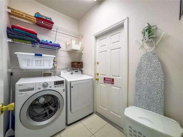 429 Belfry Dr, Davenport, FL 33897 - washroom featuring washing machine and clothes dryer and light tile patterned flooring