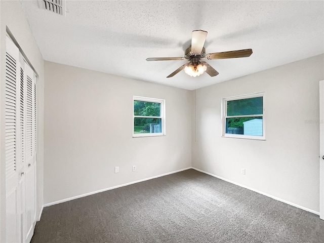 801 NE 4th Ave, Mulberry, FL 33860 - unfurnished bedroom with carpet flooring, a closet, ceiling fan, and a textured ceiling