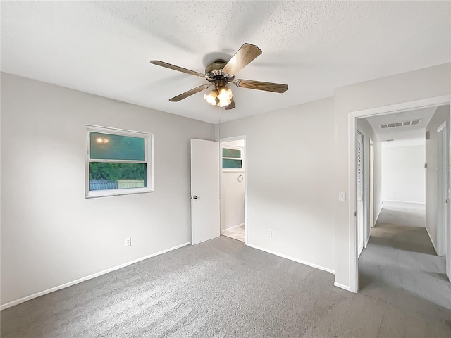 801 NE 4th Ave, Mulberry, FL 33860 - unfurnished bedroom with carpet flooring, a textured ceiling, and ceiling fan