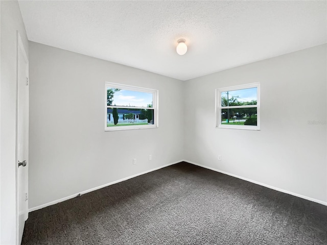 801 NE 4th Ave, Mulberry, FL 33860 - empty room featuring dark carpet and a textured ceiling