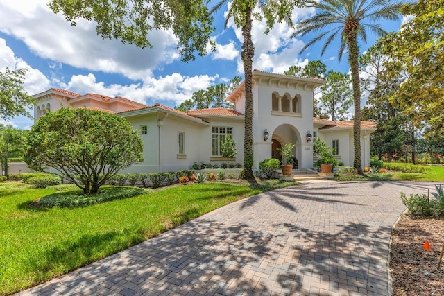 6186 Louise Cove Dr, Windermere, FL 34786 - mediterranean / spanish home with stucco siding, a tile roof, and a front yard