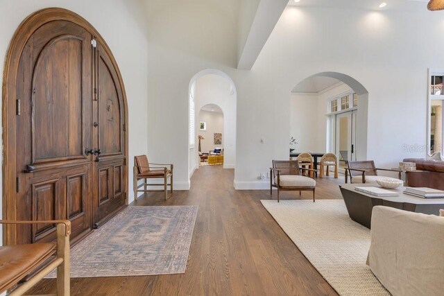 6186 Louise Cove Dr, Windermere, FL 34786 - foyer entrance with arched walkways, dark wood-type flooring, and a high ceiling