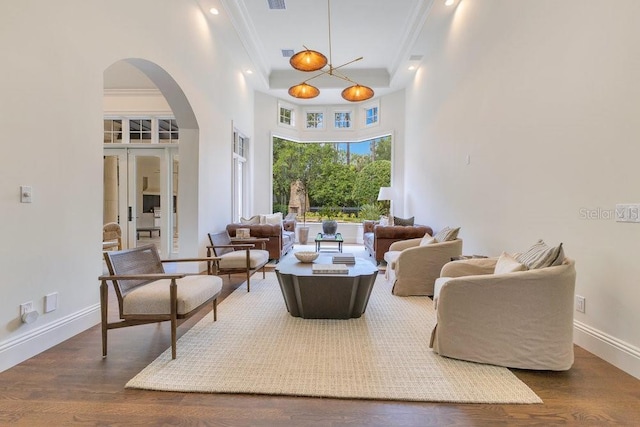 6186 Louise Cove Dr, Windermere, FL 34786 - living area with crown molding, arched walkways, wood finished floors, and a towering ceiling