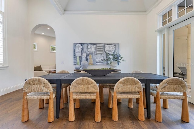 6186 Louise Cove Dr, Windermere, FL 34786 - dining area featuring wood finished floors, ornamental molding, arched walkways, a high ceiling, and recessed lighting