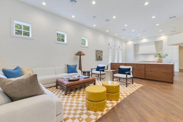 6186 Louise Cove Dr, Windermere, FL 34786 - living room featuring light wood finished floors, plenty of natural light, and recessed lighting
