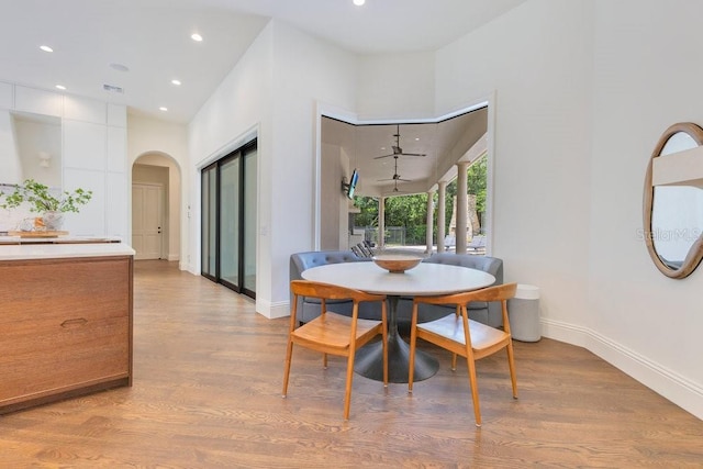 6186 Louise Cove Dr, Windermere, FL 34786 - dining area with arched walkways, light wood finished floors, and recessed lighting