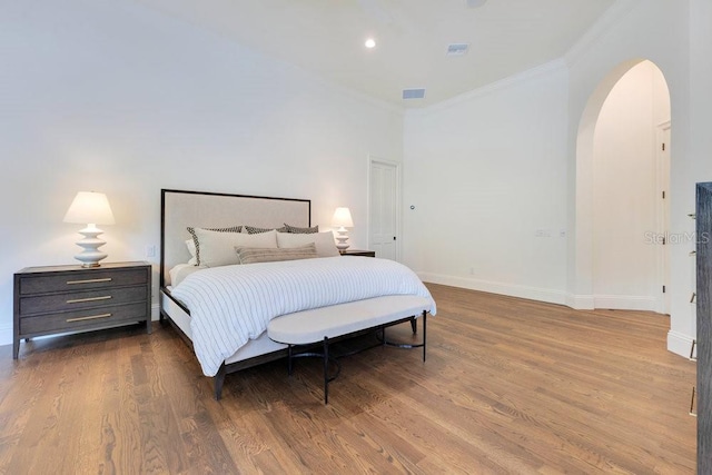 6186 Louise Cove Dr, Windermere, FL 34786 - bedroom featuring arched walkways, ornamental molding, wood finished floors, and recessed lighting