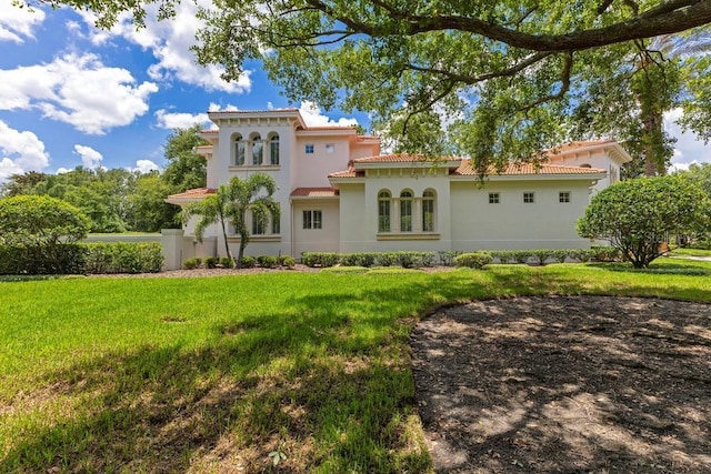 6186 Louise Cove Dr, Windermere, FL 34786 - rear view of house featuring stucco siding, a yard, and a tile roof