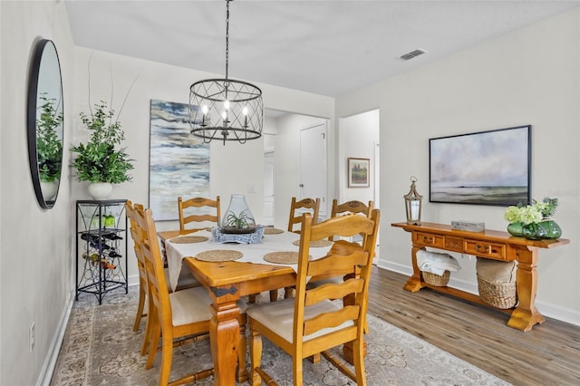 5723 Tarleton Way, Mount Dora, FL 32757 - dining space featuring wood finished floors and a chandelier