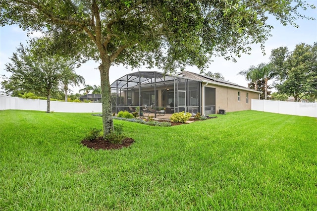 5723 Tarleton Way, Mount Dora, FL 32757 - rear view of property with a fenced backyard and glass enclosure