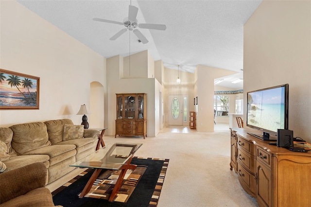 3707 Doune Way, Clermont, FL 34711 - living room featuring ceiling fan, light carpet, high vaulted ceiling, and arched walkways
