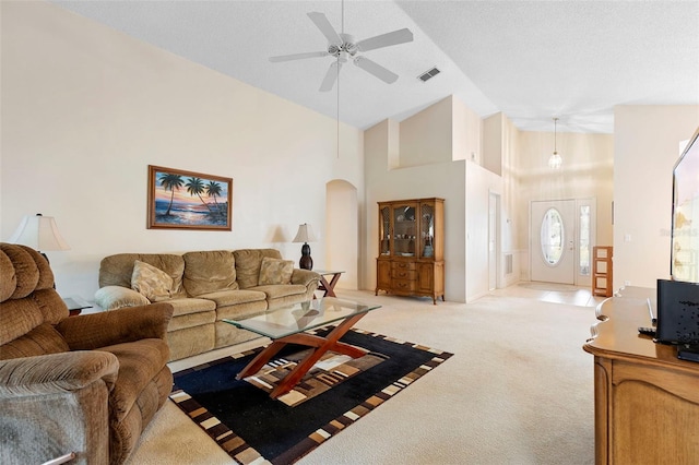 3707 Doune Way, Clermont, FL 34711 - living area featuring light carpet, ceiling fan, arched walkways, and high vaulted ceiling