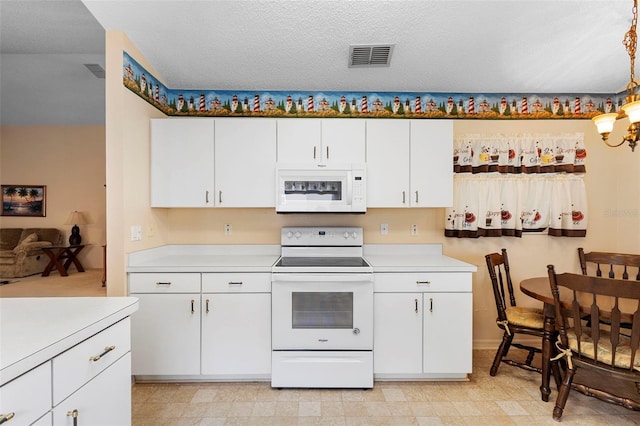 3707 Doune Way, Clermont, FL 34711 - kitchen with white appliances, light countertops, white cabinetry, and hanging light fixtures