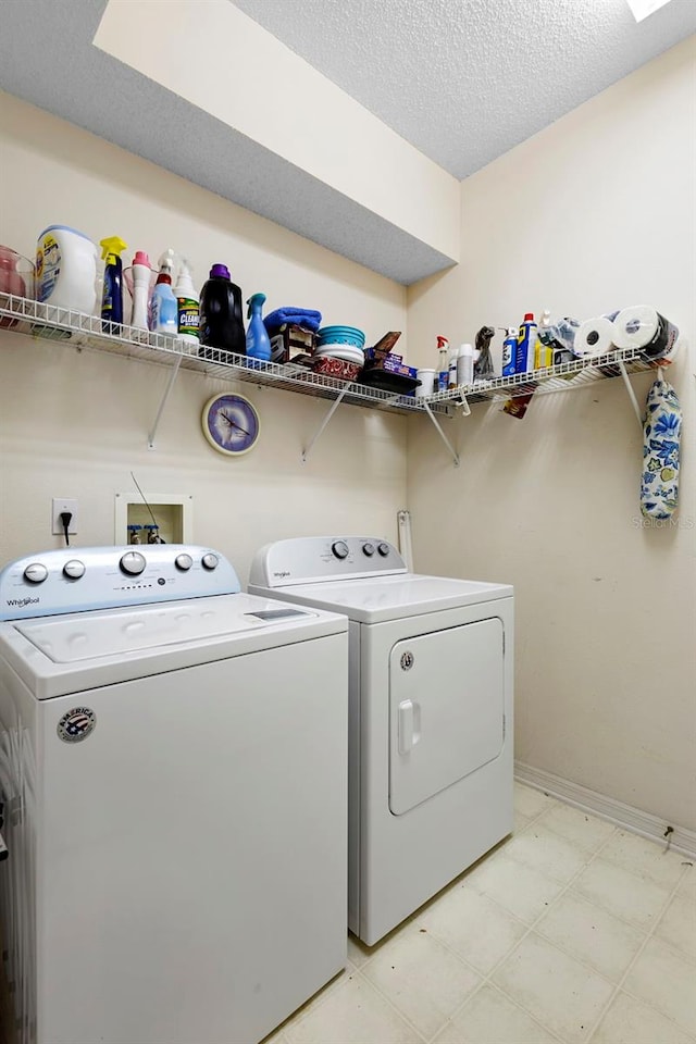 3707 Doune Way, Clermont, FL 34711 - laundry room featuring separate washer and dryer, a textured ceiling, and light flooring