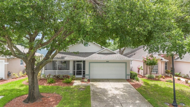3707 Doune Way, Clermont, FL 34711 - view of front facade featuring a shingled roof, a porch, an attached garage, a front yard, and concrete driveway