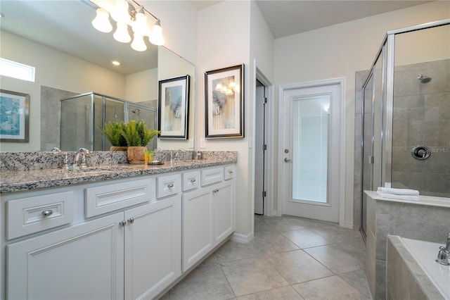 1907 Summer Dr, Davenport, FL 33897 - bathroom with double vanity, a shower stall, a bath, tile patterned floors, and a chandelier