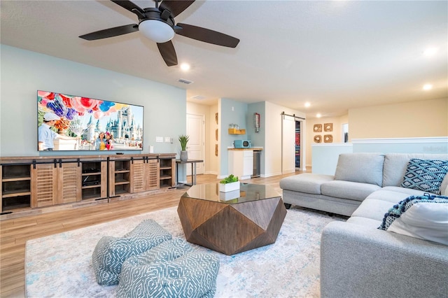 1907 Summer Dr, Davenport, FL 33897 - living area featuring a barn door, wood finished floors, a ceiling fan, and recessed lighting