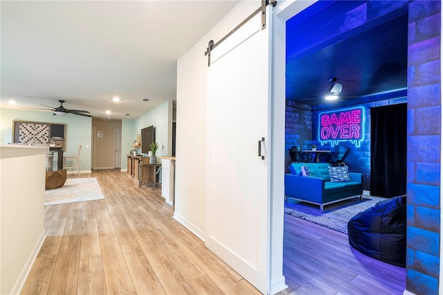 1907 Summer Dr, Davenport, FL 33897 - hall featuring a barn door, light wood-style flooring, and recessed lighting