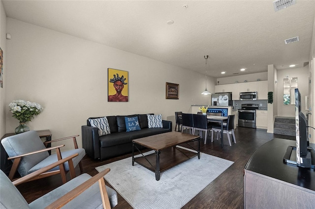 2900 Edenshire Way Unit 107, Kissimmee, FL 34746 - living room with recessed lighting and dark wood-style flooring