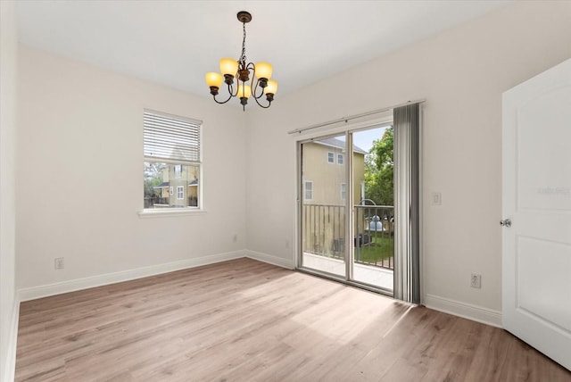 11 W Harding St Unit E, Orlando, FL 32806 - spare room featuring a chandelier and light wood-type flooring