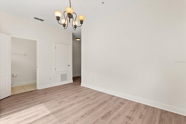 11 W Harding St Unit E, Orlando, FL 32806 - spare room featuring a chandelier and light wood-type flooring