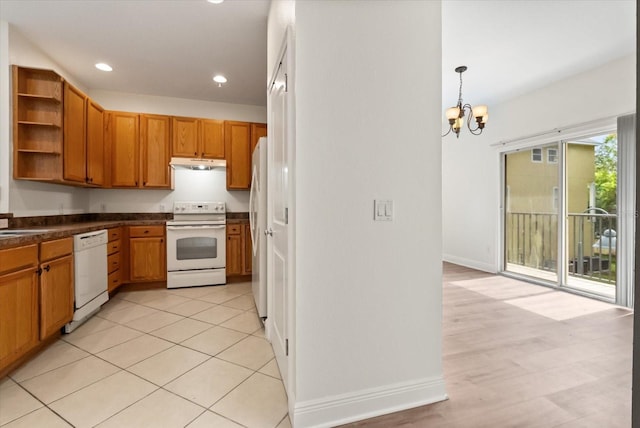 11 W Harding St Unit E, Orlando, FL 32806 - kitchen featuring white appliances, under cabinet range hood, open shelves, a chandelier, and dark countertops