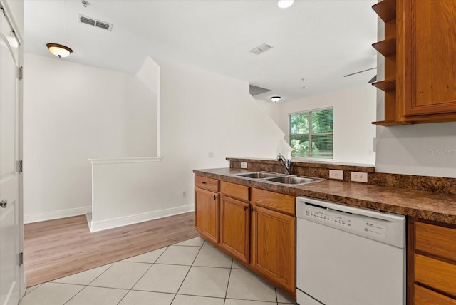 11 W Harding St Unit E, Orlando, FL 32806 - kitchen featuring dishwasher, open shelves, dark countertops, brown cabinets, and light tile patterned floors